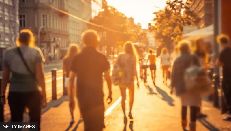 people walking into the sunset